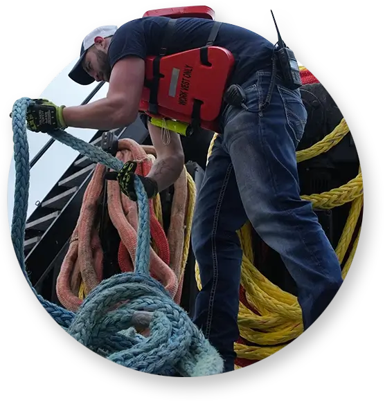 A Southern Devall crewman handling rope on the deck of a barge