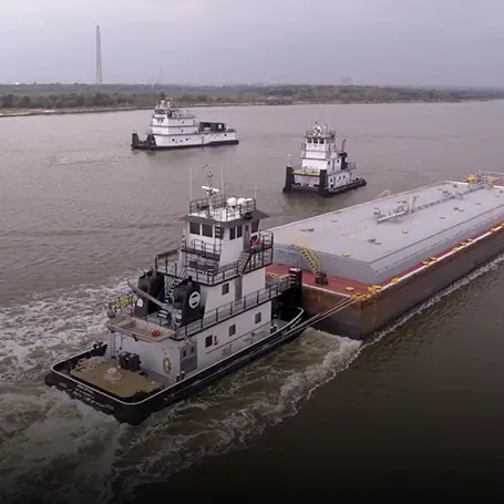 Three Southern Devall towboats moving through a bay