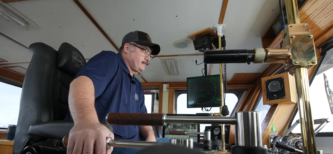 A Southern Devall captain manning his post inside the cockpit of a barge