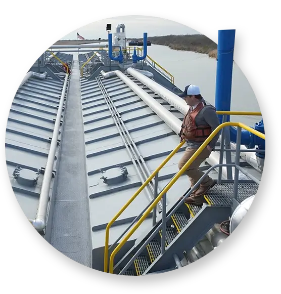 A deck hand going down stairs on top of a Southern Devall barge