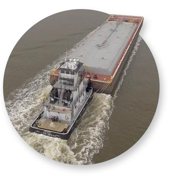 A large Southern Devall barge carrying fertilizer up river