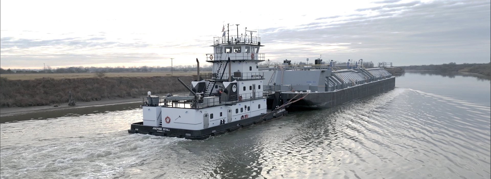 The Joesphine Devall barge towing fertilizer down a river