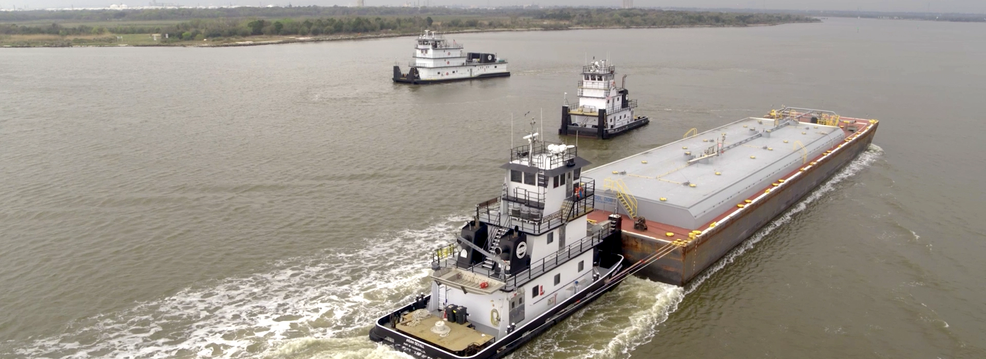 Three Southern Devall barges traveling down a river