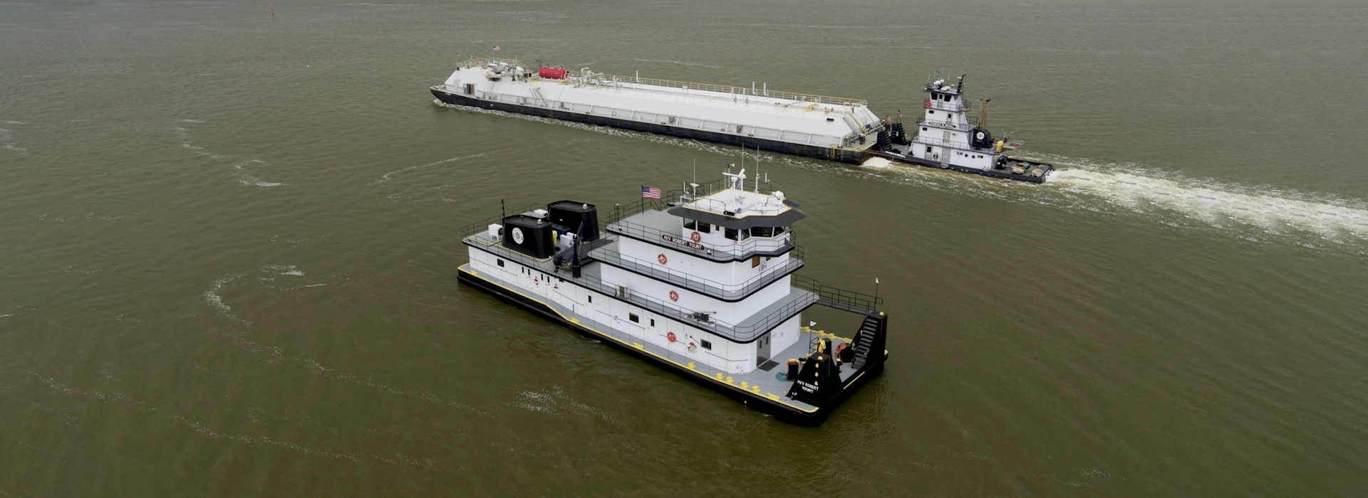 Southern Devall barges heading in opposite directions down a waterway