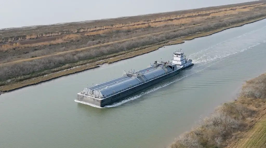 A Southern Devall barge heading down a river