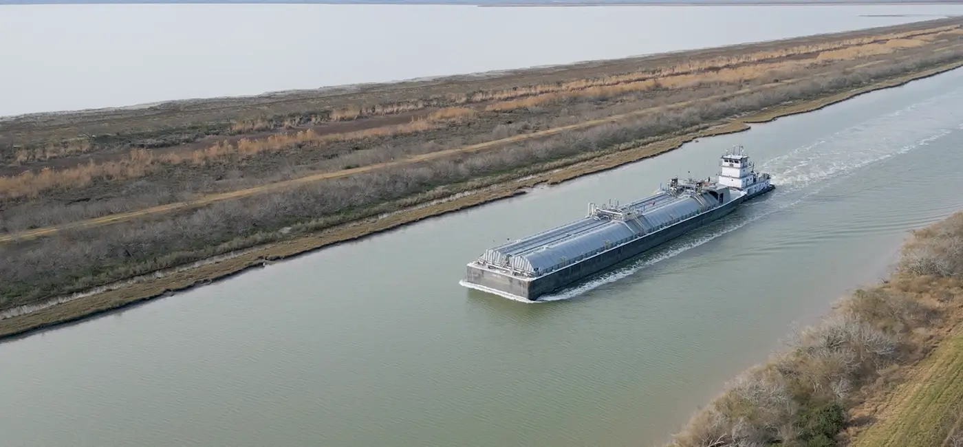 A Southern Devall barge heading down a river