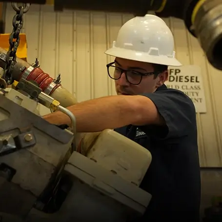 A Southern Devall technician working on a diesel engine
