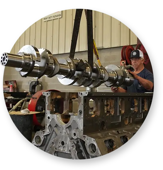 A Southern Devall technician taking apart a large diesel engine