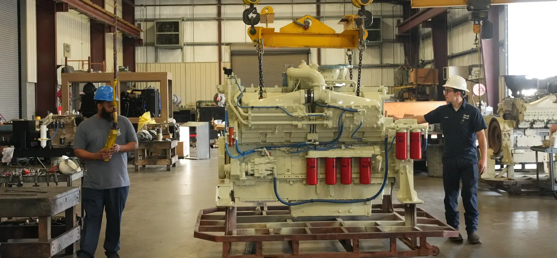 Southern Devall technicians preparing to lift a diesel engine up to work on it