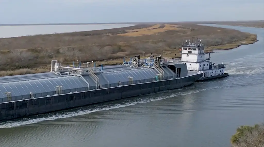 A Southern Devall barge moving up river from a bay