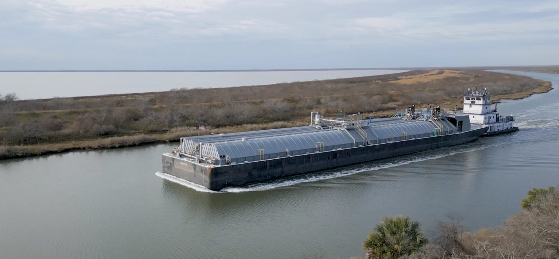 A Southern Devall barge moving up river from a bay