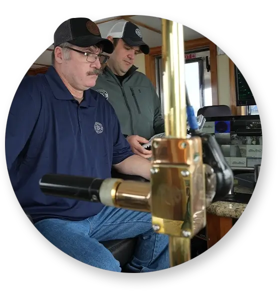 Two Southern Devall crewman manning the helm of a two boat