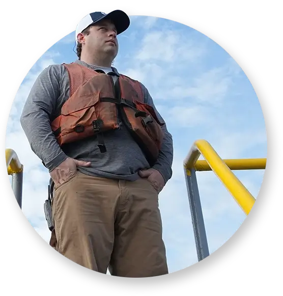 A Southern Devall deckhand looking out over a yellow railing