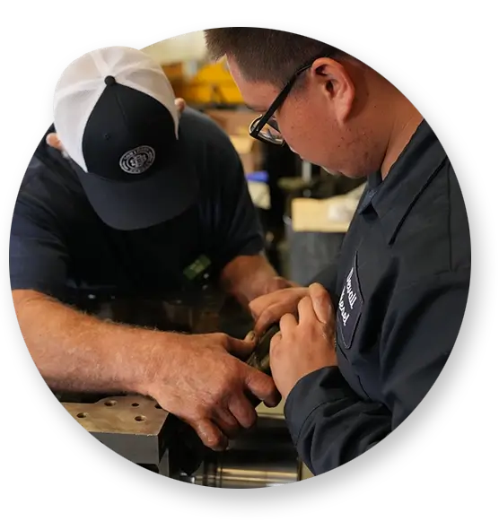 Two Southern Devall technicians working to tighten a piece of machinery