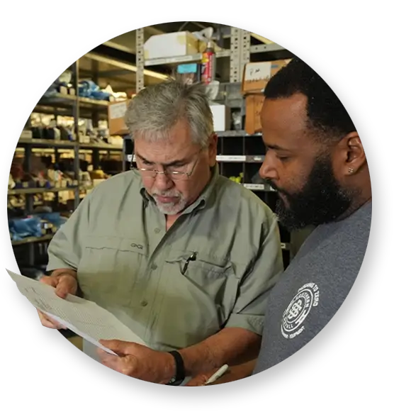 Two Southern Devall employees looking over paperwork in a warehouse
