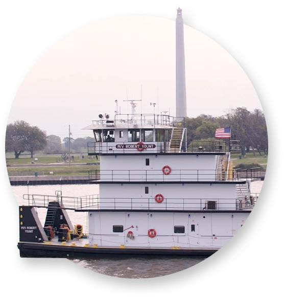 A Southern Devall barge floating by the San Jacinto Monument in Houston
