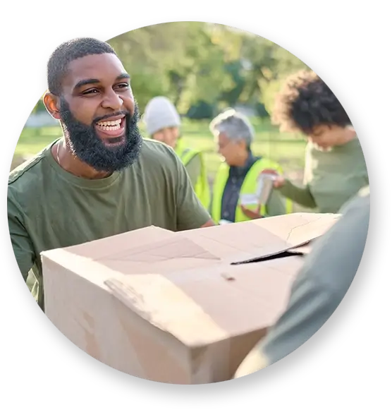 A Southern Devall employee handing over a box at a volunteer event